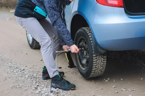 man-is-changing-tire-with-wheel-car-scaled.webp
